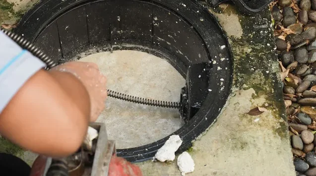 Technician inspecting a residential drain line with camera equipment